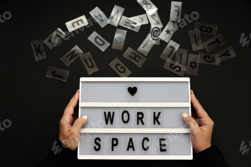 Preview: Creative desktop top view. Table with letters workspace with woman hands