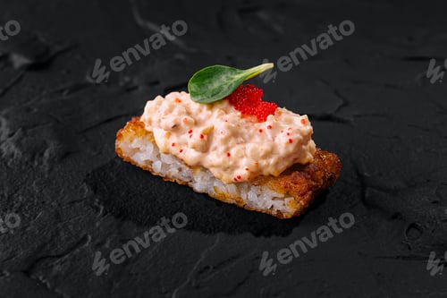 Preview: Gourmet sushi roll with caviar on slate background
