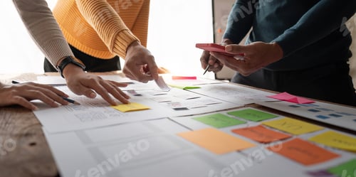 Preview: Close up ux developer and ui designer brainstorming about mobile app interface wireframe design on