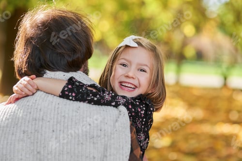 Preview: Portrait of happy girl embracing her daddy
