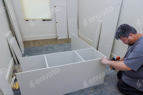 Preview: Carpenter was in process of assembling furniture closet cabinet that needed to be the installed