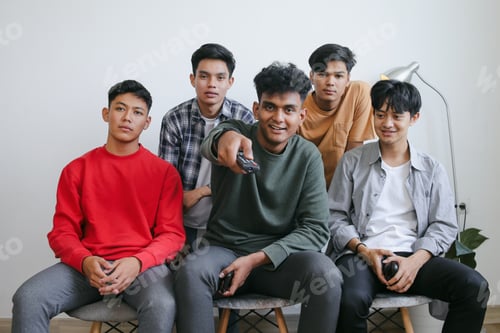 Preview: Group Of Young Friends Smiling Happy Watching Movie At Home