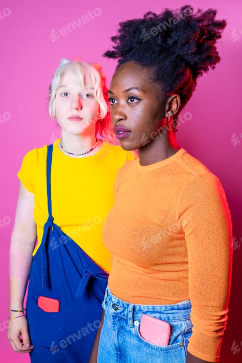 Preview: Two young diverse multicultural caucasian and black women best friends posing isolated background