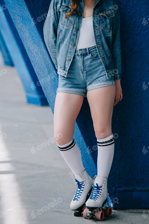 Preview: cropped shot of stylish woman in denim clothes, high socks and retro roller skates