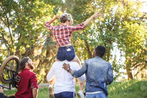 Preview: Young coupe in park. Boyfriend carrying his girlfriend on piggyback.