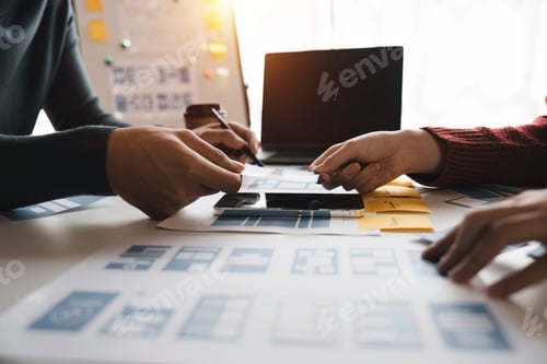 Preview: Close up ux developer and ui designer brainstorming about mobile app interface wireframe design at