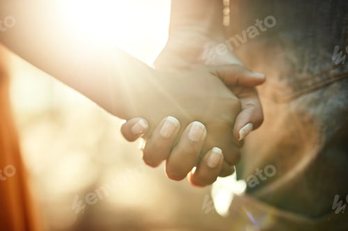 Preview: Their bond is too precious. Closeup shot of an adult holding a childs hand outside.