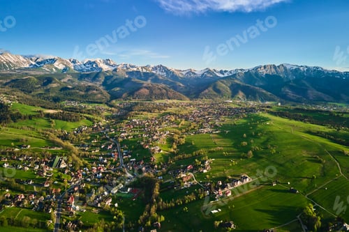 Preview: Aerial view of Tatra mountains and Zakopane town at sunset