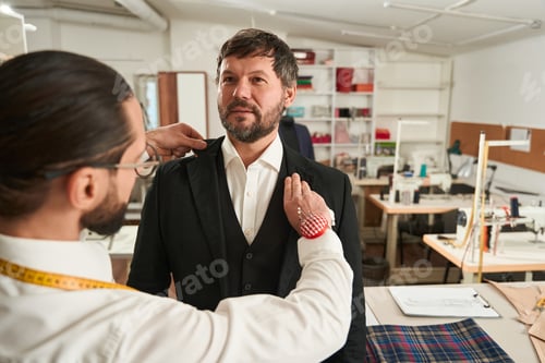 Preview: Man Getting Fitted for Suit by a Tailor