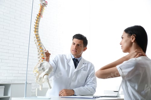 Preview: Young woman visiting orthopedist in medical office