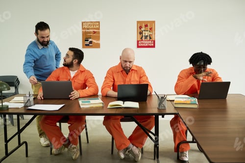Preview: Middle Aged Caucasian Man Teaching Multiethnic Inmates Using Laptops
