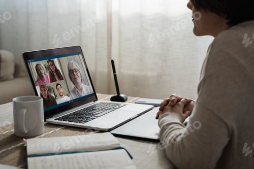 Preview: Back view of business people streaming online on video call conference - Main focus on keyboard