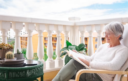 Preview: Senior Woman Relaxing Reading on a Balcony