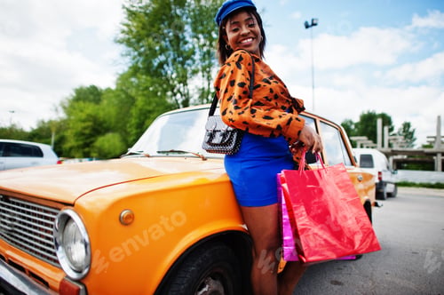 Preview: African american lady near orange classic retro car