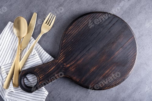 Preview: Wooden cutting board or food serving board with napkin and cutlery