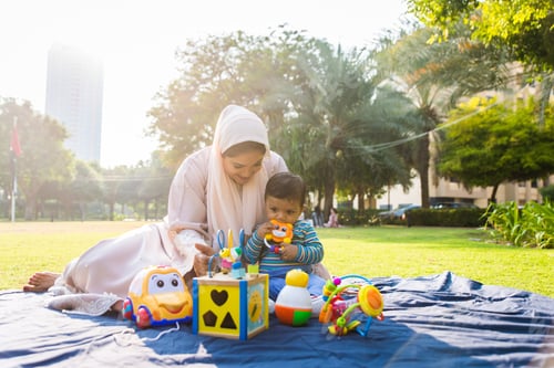 Preview: Arabic mom and her little toddler playing outdoors
