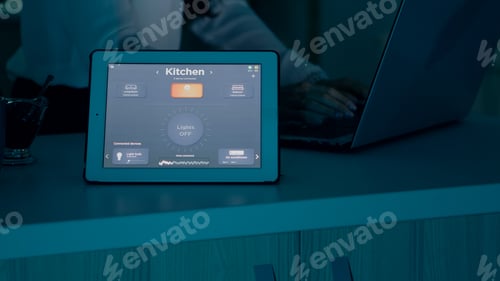 Preview: Female typing on laptop working from home with automation lighting system