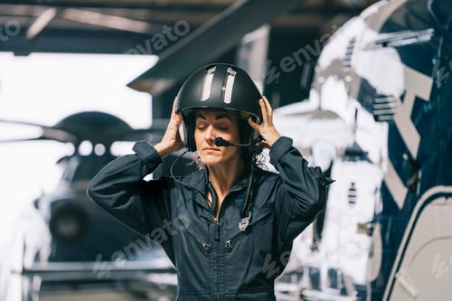 Preview: Pilot girl poses with her helicopter wearing helmet