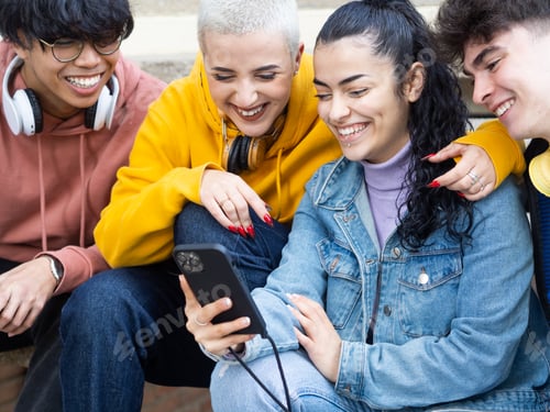 Preview: Group of young students looking at smart phone smiling. social media, having fun