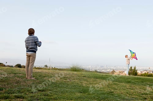Preview: Young couple in field with kite