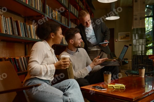 Preview: Business freelance team chatting during coffee break in office