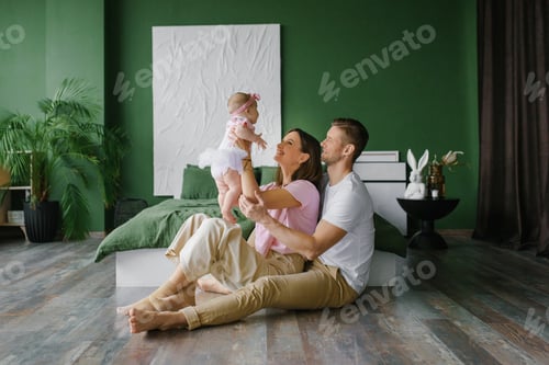 Preview: Mother Lifting Baby Girl While Father Watches