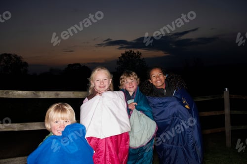 Preview: Children in sleeping bags at dusk