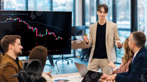 Preview: Young worker leading business meeting about cryptocurrencies in an office