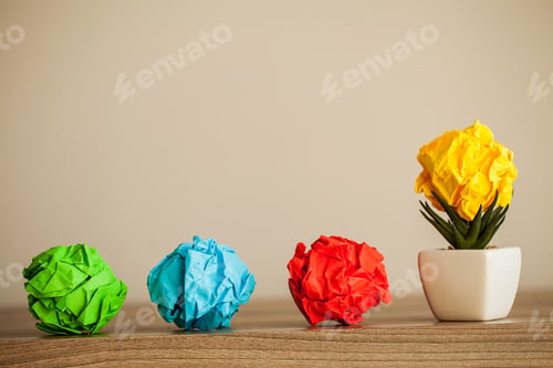 Preview: Great idea concept. Crumpled colorful paper on wooden table. Copy space
