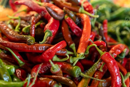 Preview: Closeup of red and green hot peppers against blurred background