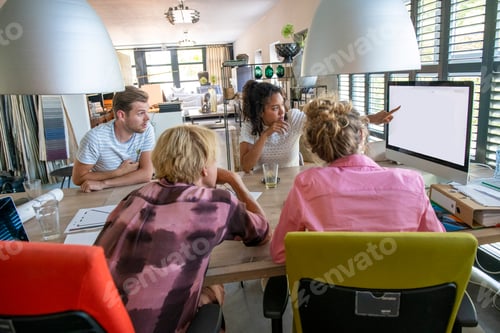 Preview: A diverse team engaged in a creative brainstorming session in a bright home office.
