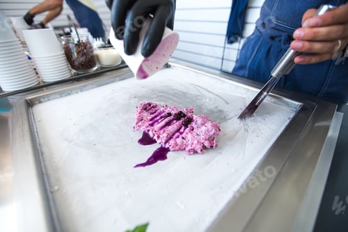 Preview: Stir-fried ice cream rolls at freeze pan. Rolled ice cream, hand made ice cream dessert. Fried ice
