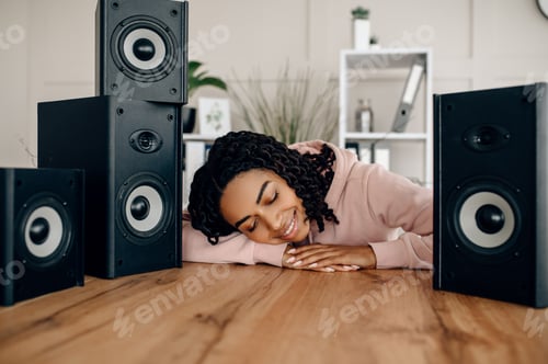 Preview: Cute happy woman between many audio speakers