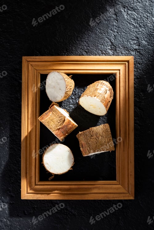Preview: pile of cassava and cassava flour on dark background (Manihot esculenta)