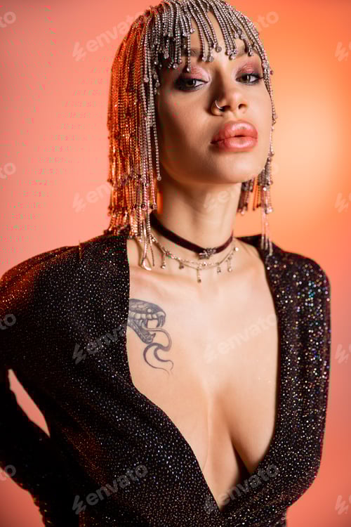 Preview: portrait of sensual woman with sexy tattooed body posing in black dress and silver wig with