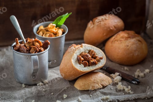 Preview: Homemade bun with mushrooms on old wooden table