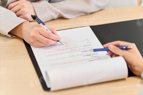 Preview: A woman signing a real estate contract
