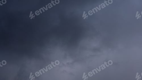 Preview: Dark storm clouds make the sky in black. Rain is coming soon. Nature background.