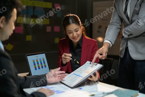 Preview: Business Team Collaborating on Project in Modern Office with Charts and Graphs
