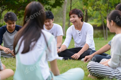 Preview: Happy young group of friends having fun together at the park