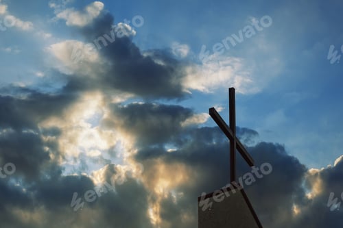 Preview: cross and church steeple at dusk silhouette with the as background