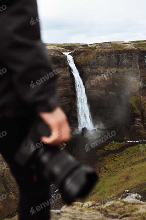 Preview: Traveler by a waterfall