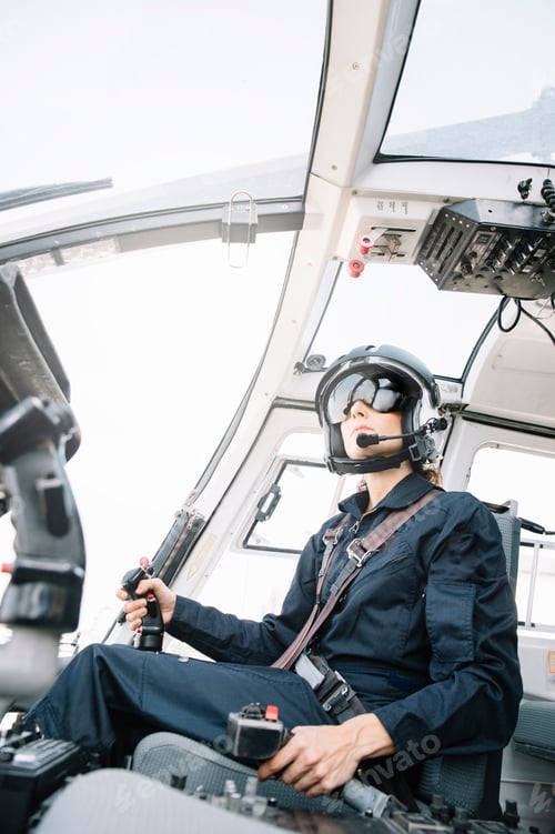 Preview: Attractive woman pilot sitting in the helicopter