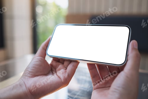 Preview: Mockup image of a woman holding and using mobile phone with blank desktop screen
