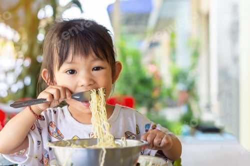 Preview: Smiling Child Enjoying Noodles at Home