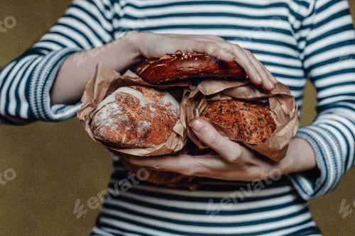 Preview: a girl in a striped sweater holds bread in a craft bag