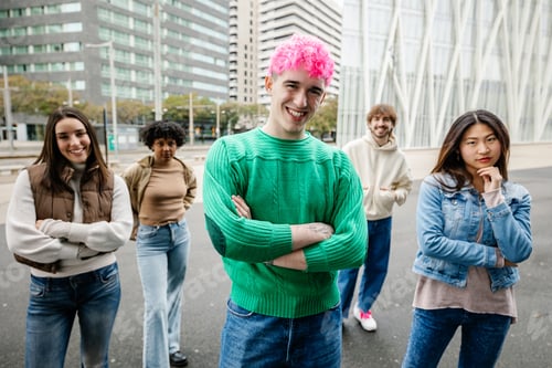 Preview: Young millennial friends outdoors with one student in focus and group behind