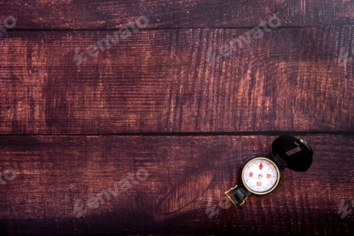 Preview: Isolated compass on a brown aged wooden table, copy space.