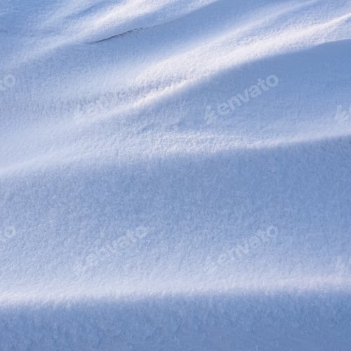 Preview: Snowdrift waves in sunset light, winter background of snow waves