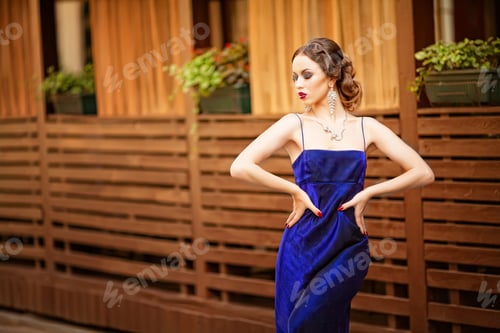 Preview: Beautiful young woman wearing a violet dress walking and posing